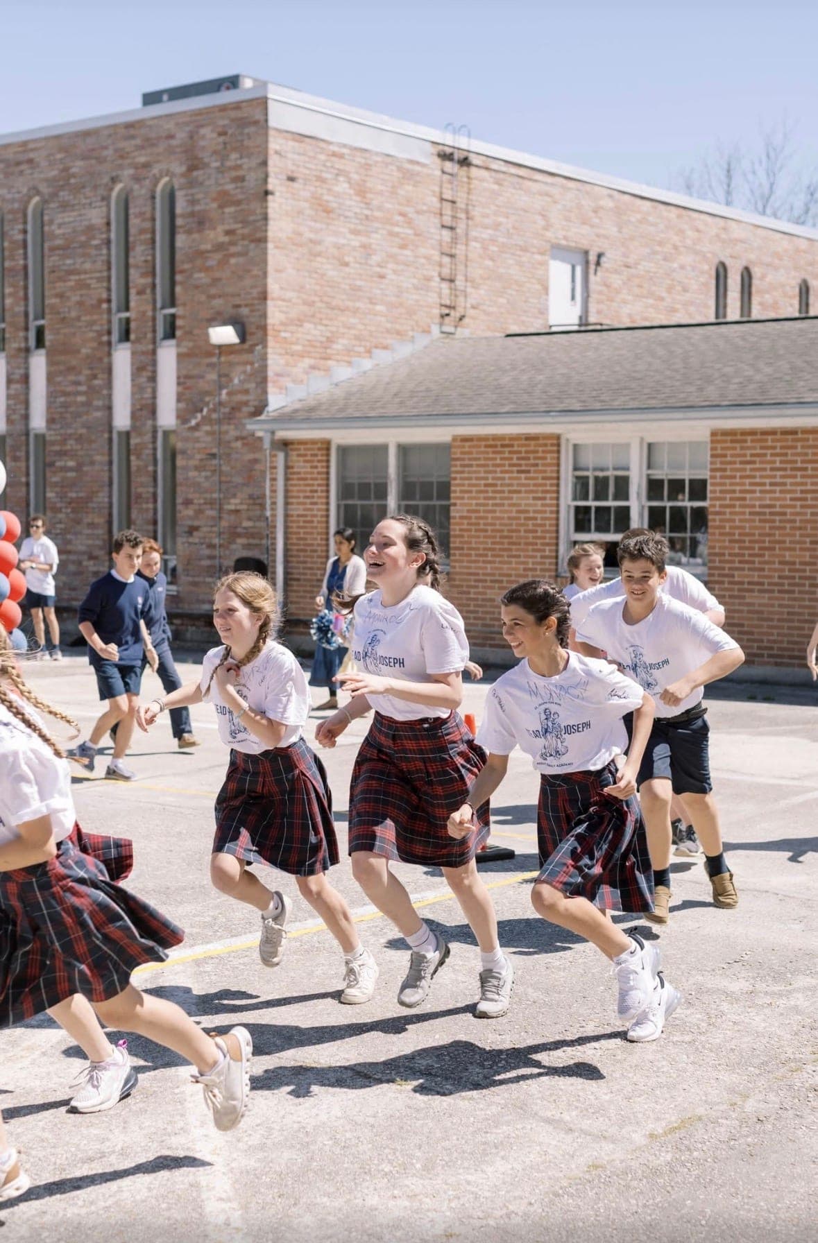Holy Family Academy students running a past Fun Run